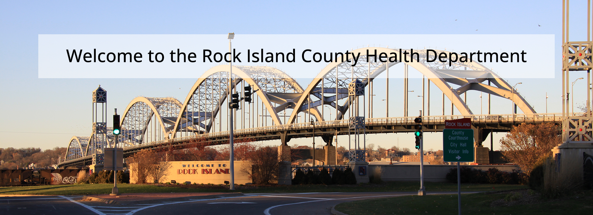 Photo of the Centennial Bridge with a Welcome to Rock Island sign in the foreground and a text overlay that says Welcome to the Rock Island Health Department